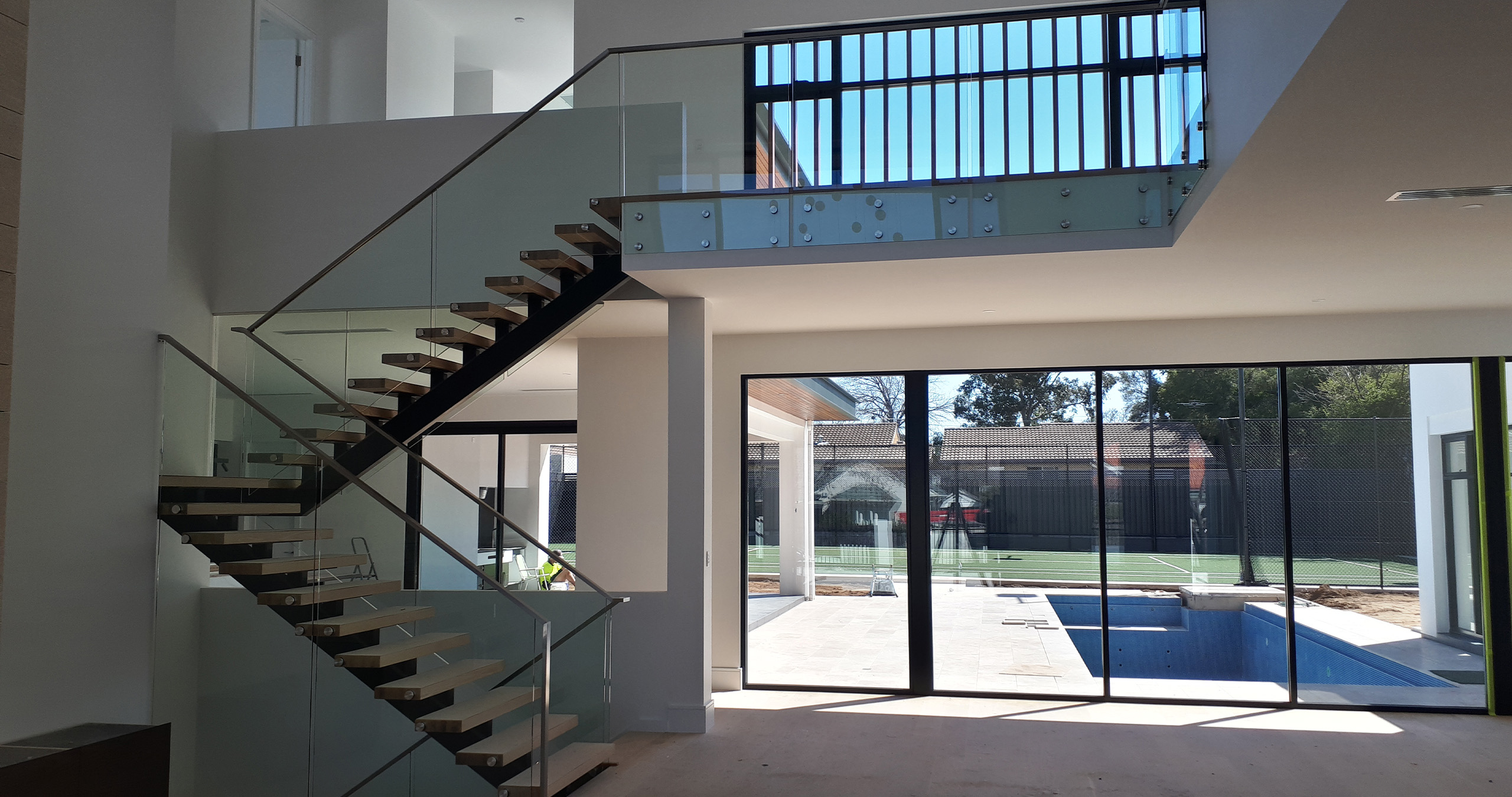 Floating steel staircase fabricated for residential home in Adelaide with glass balustrade